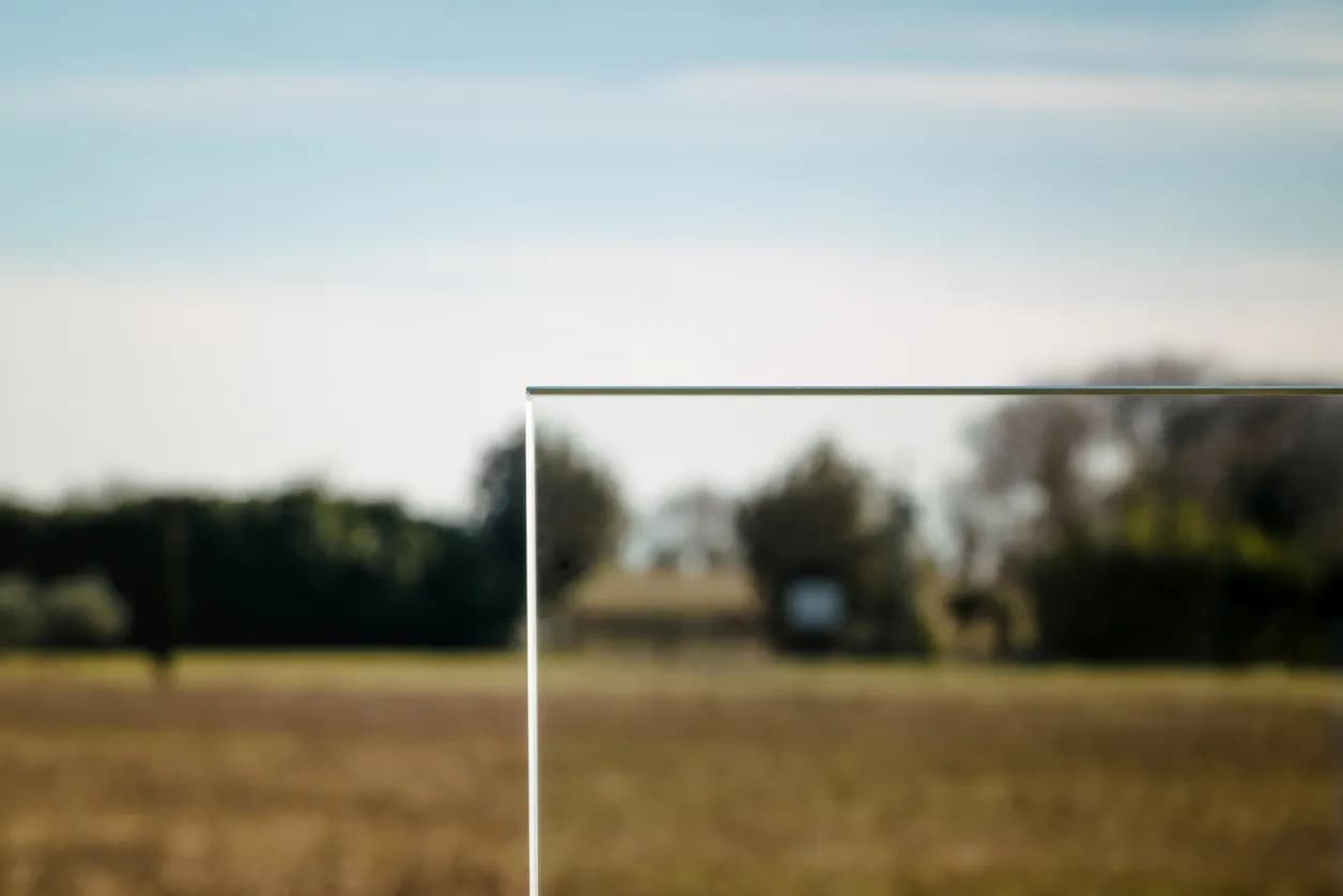 Glass panel detail reflecting the surrounding garden